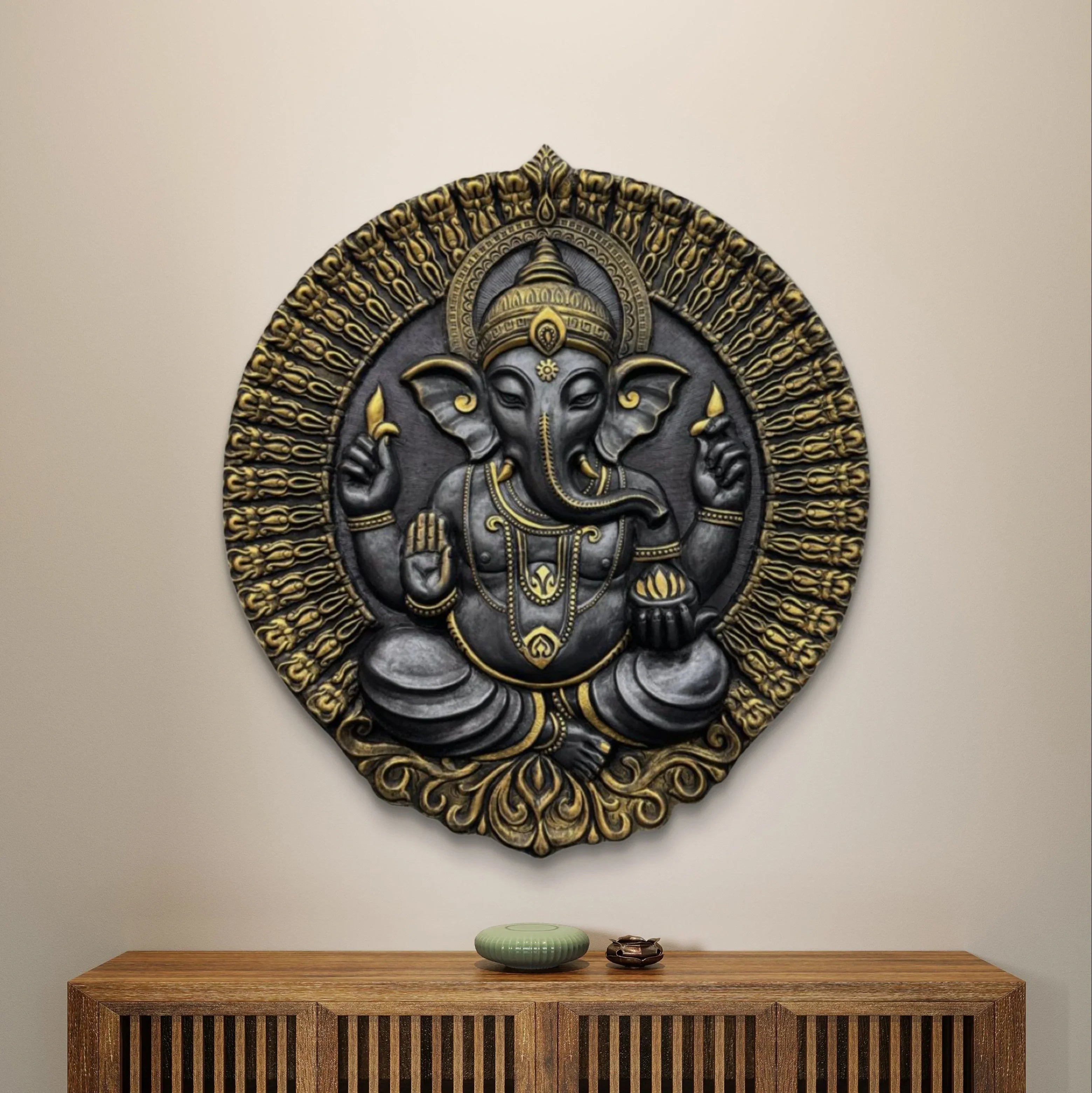 Handcrafted Ganesha mural painting with intricate detailing and golden accents, displayed on a wooden console table.