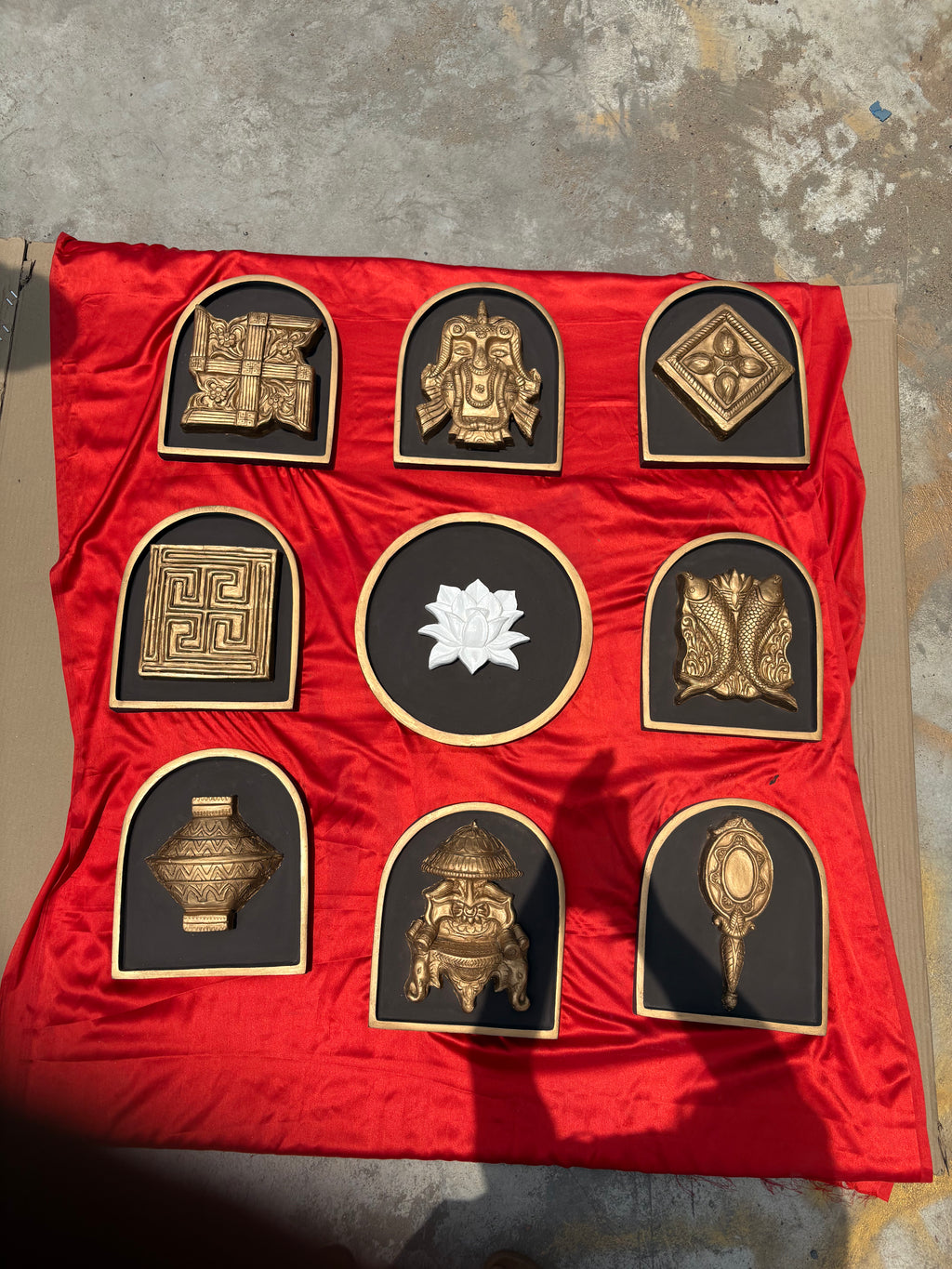 Detailed texture of Ashtamangala wall art sculptures showing layered relief craftsmanship