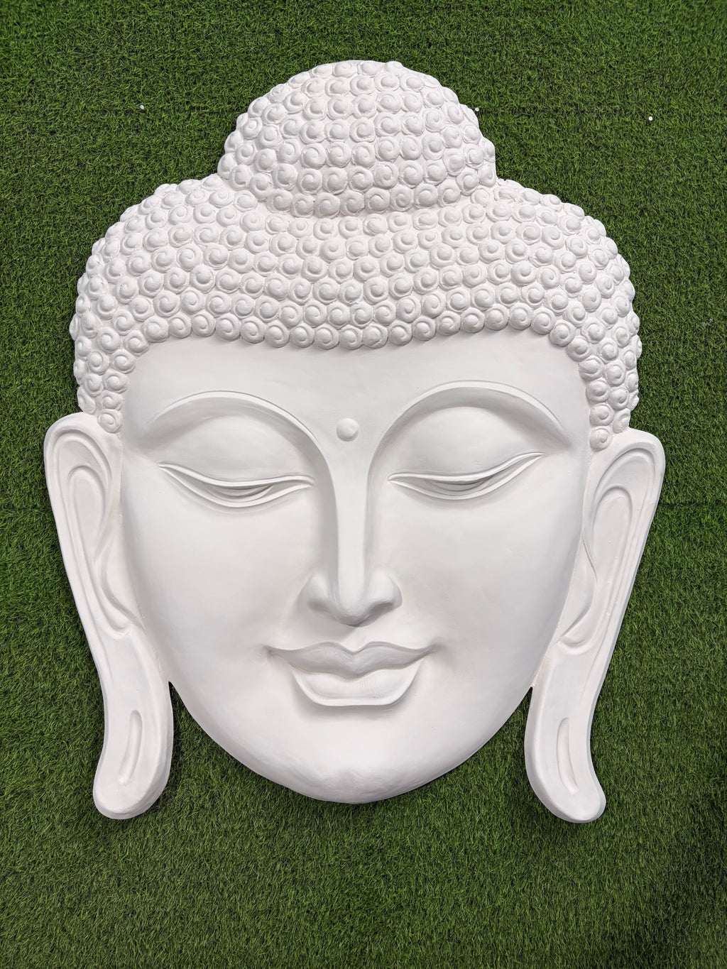 High relief 3D Buddha face mural wall art for home decor, adds peace and depth to modern interiors.