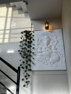 Unframed white finish 4x3 feet Dancing Ganesha 3D relief mural, handcrafted wall art for modern spiritual and minimal interiors.