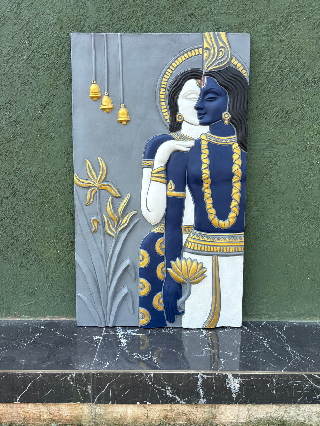 Detailed texture of abstract Radha Krishna wall sculpture showing layered relief craftsmanship.