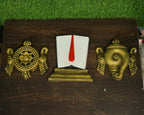 Fiber Mural of Shankha Namam Chakra set installed above a wooden panel